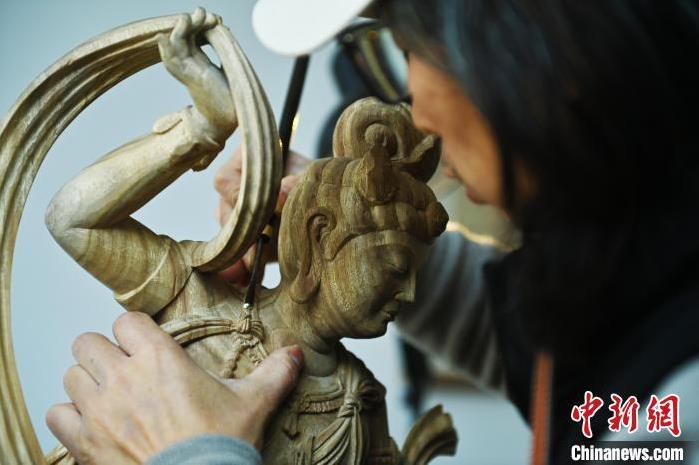 圖為季茂杰進行敦煌元素的木雕創(chuàng)作。李亞龍 攝</p>
<p>